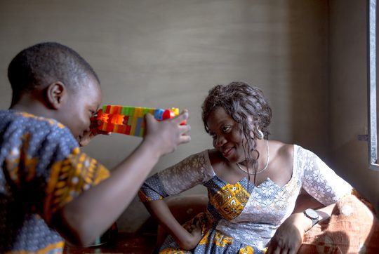 Mohamed uses his carefully constructed lego to “photograph" his mother in their living room. Mohamed, 6 is Zainabs first child.Shortly after giving birth to him, Zainab haemorrhaged and with the advice of a Doctor in UCH, Ibadan she agreed to take Tranexamic
 acid. Zainab is convinced that if she did not agree to take the Tranexamic acid, she would have died